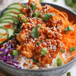 Irresistible Bang Bang Chicken Bowl – 1 Sweet & Spicy Meal Prep Favorite 7 Bang Bang Chicken Bowl with crispy glazed chicken, white rice, shredded veggies, and sesame garnish in a white bowl