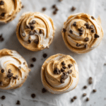 Frozen Greek Yogurt Peanut Butter Bites (Easy, Protein-Packed Snack) 5 A tray of frozen Greek yogurt peanut butter bites topped with mini chocolate chips, displayed on parchment paper—creamy, bite-sized protein snacks perfect for no-bake treats.