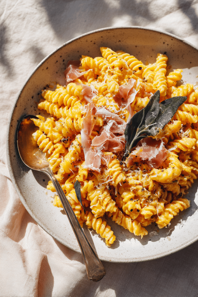 Creamy Pumpkin Pasta: The Ultimate Cozy Fall Dinner (Ready in 25 Minutes) 5 Creamy Pumpkin Pasta Close Up with Parmesan and Spoon
