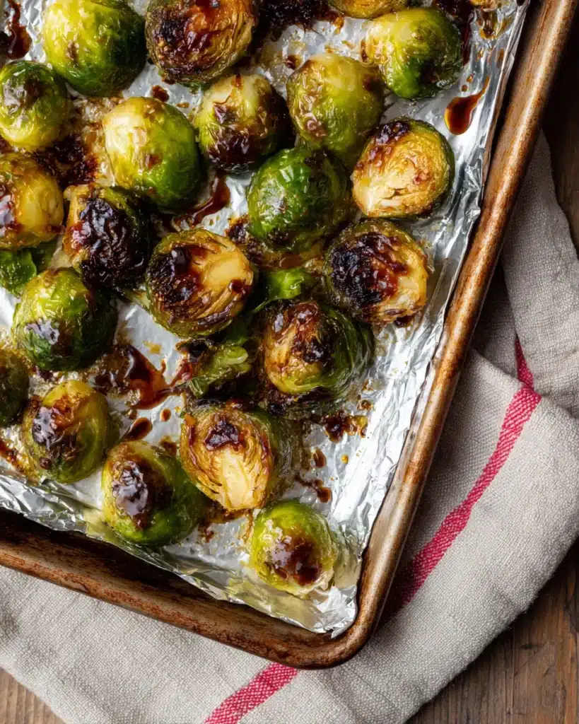 Roasted Brussels sprouts with balsamic glaze on foil-lined sheet pan
