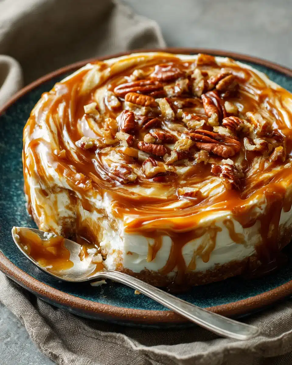 Close-up of creamy caramel apple cheesecake dip with pecans and caramel drizzle