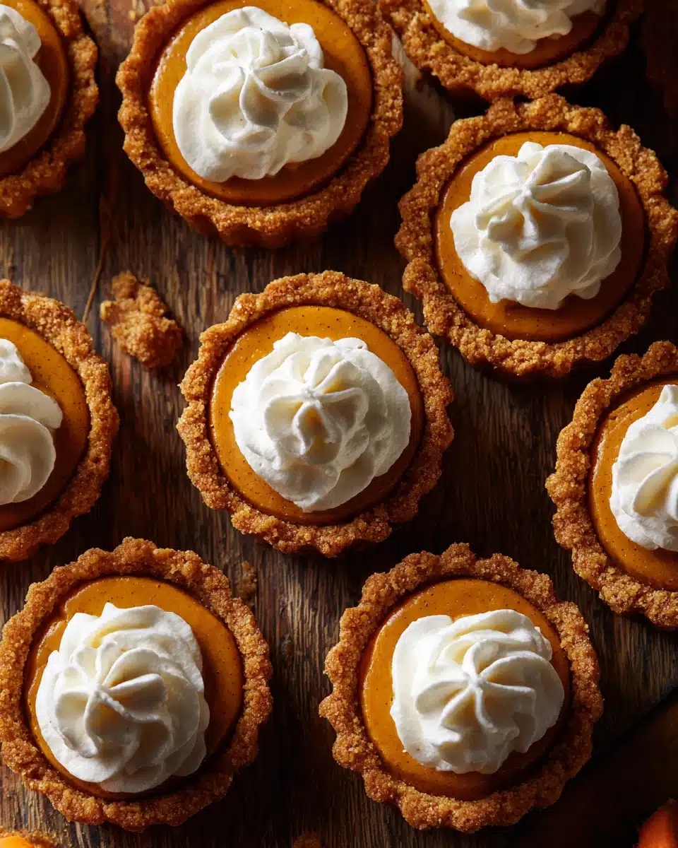 Pumpkin pie cookies with whipped cream on top, golden crust and creamy pumpkin filling.