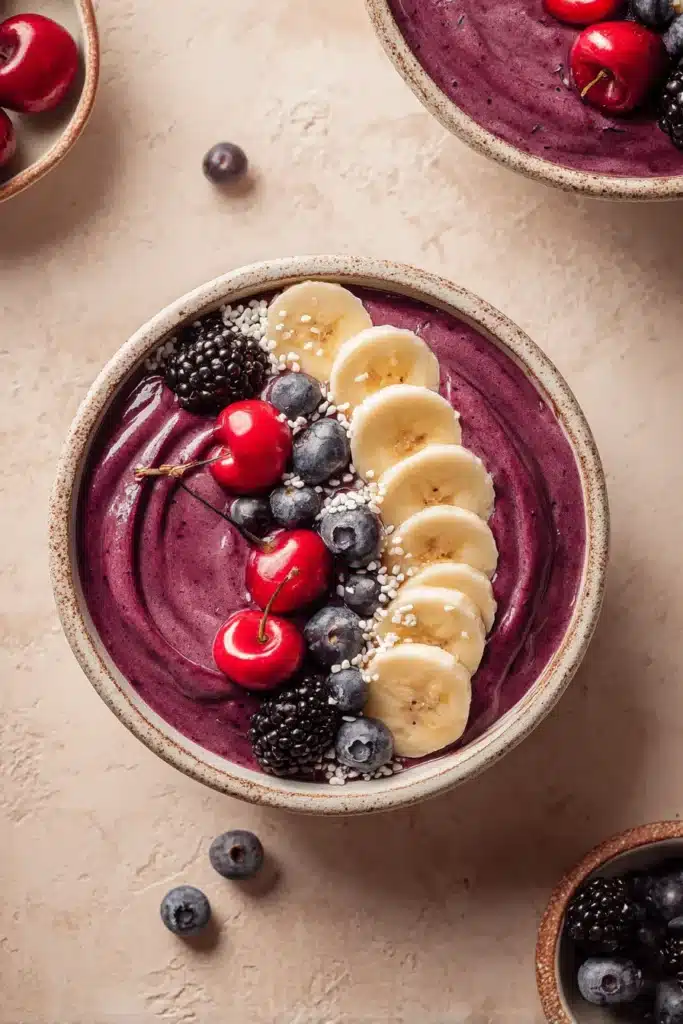 Cherry Berry Smoothie Bowl with banana slices, cherries, blueberries, and blackberries